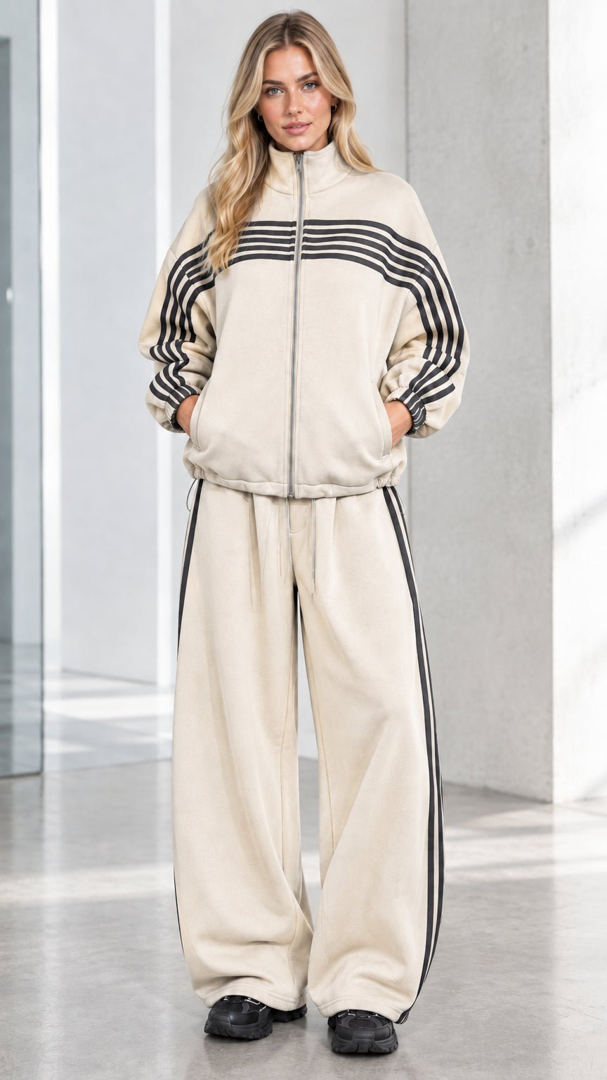 Front full view of woman wearing Beige cream striped zip-up track jacket and wide-leg sweatpants set