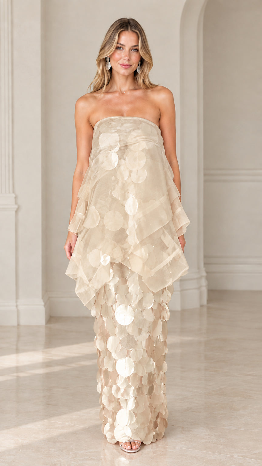 Front view of model wearing champagne gold strapless tiered organza paillette maxi dress