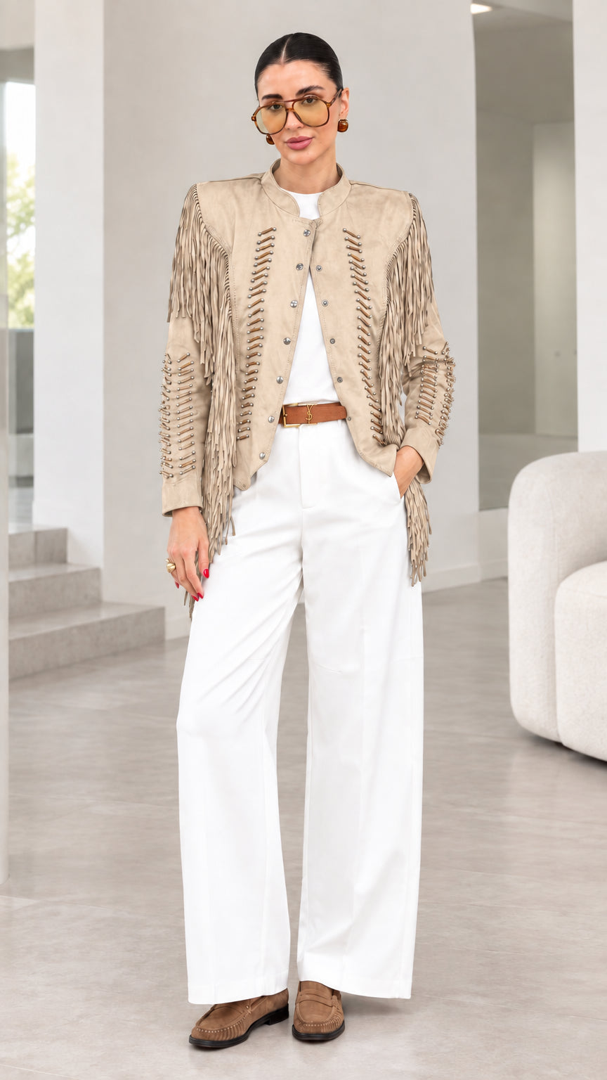 Model wearing beige tan faux suede fringe jacket with white pants