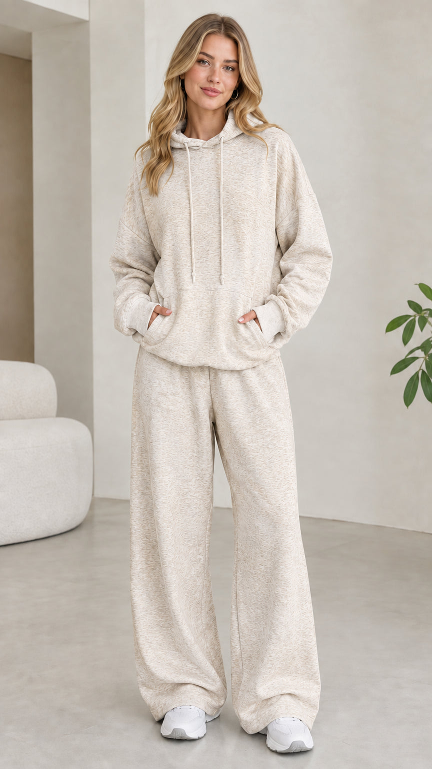 Model wearing oatmeal beige 2-piece drawstring hoodie and wide leg sweatpants set