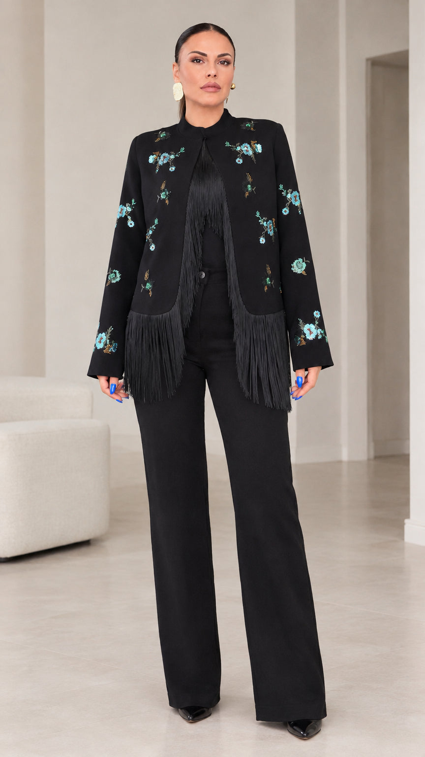 Full front view of women wearing black floral embroidered jacket with fringe hem and matching wide leg trousers