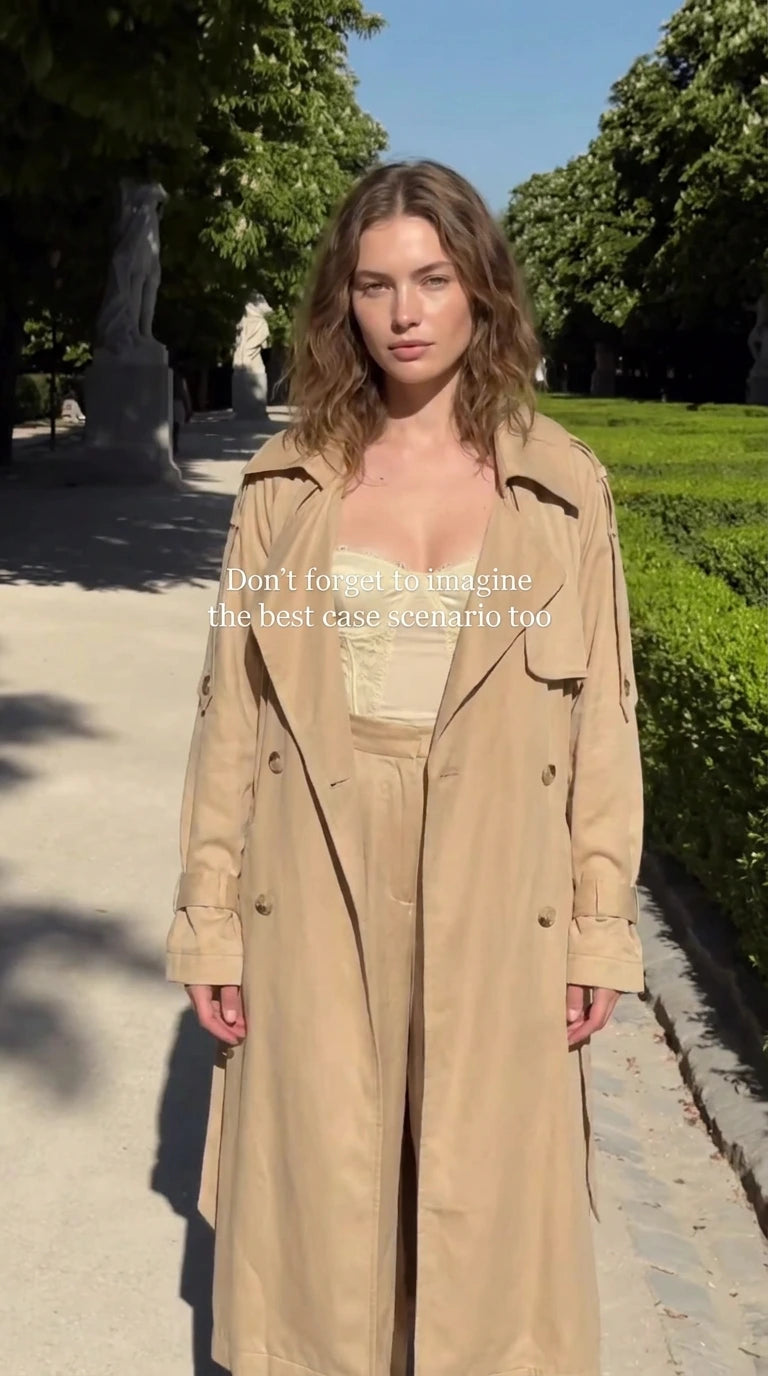 Model wearing beige maxi trench coat and matching wide-leg trousers outdoors
