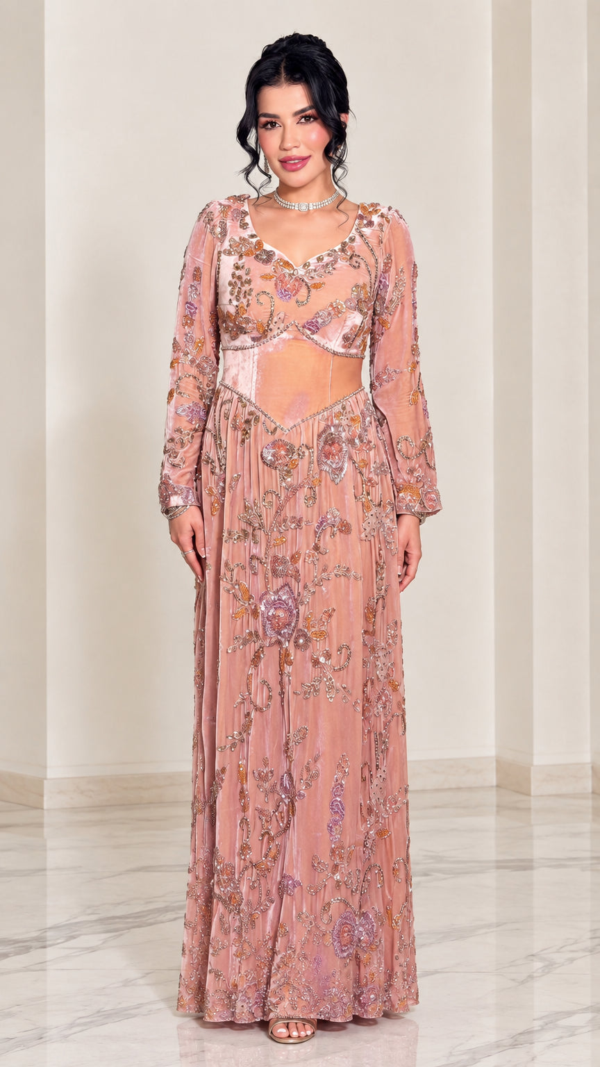 Front view of woman wearing dusty pink embroidered long sleeve evening gown with illusion waist