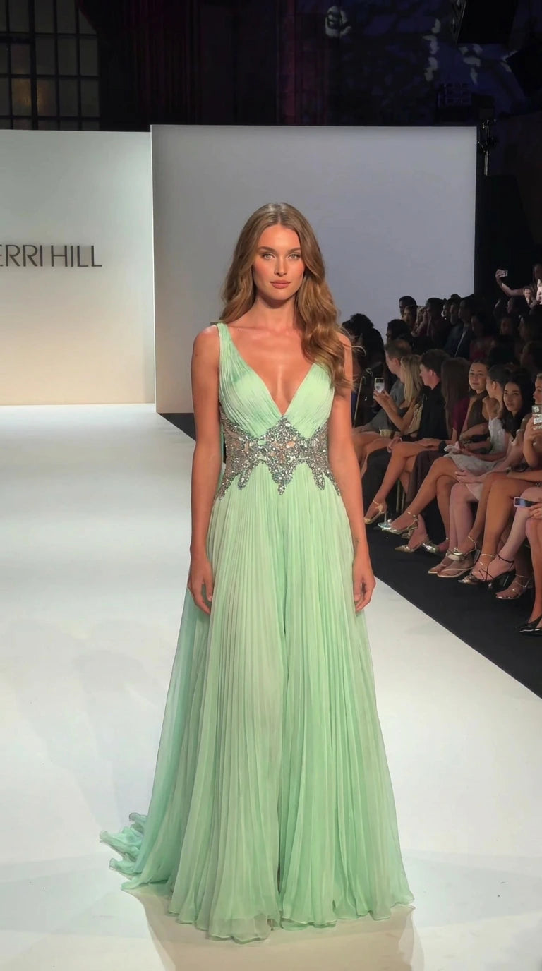 Mint green pleated floor-length evening gown with a deep V-neck and embellished waist, front view
