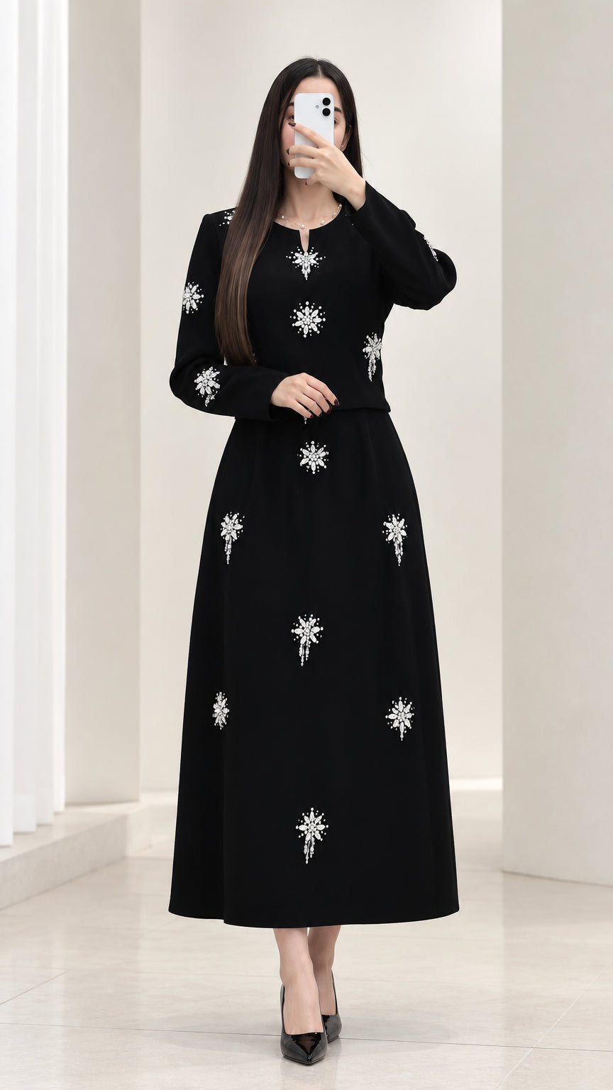 Front view of black rhinestone embellished long sleeve top and maxi skirt set