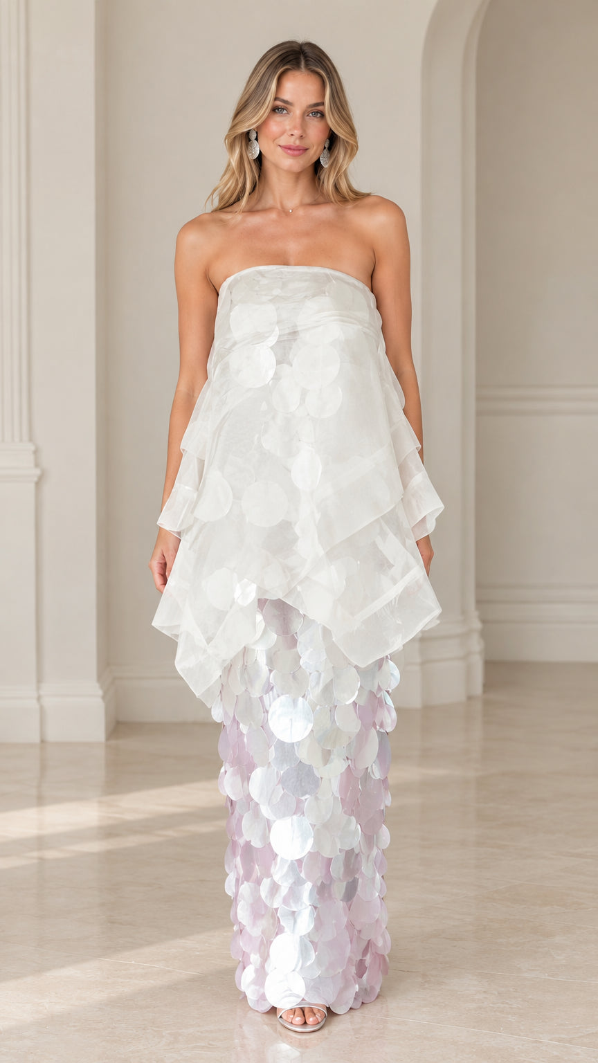 Front view of model wearing a white strapless tiered organza paillette maxi gown