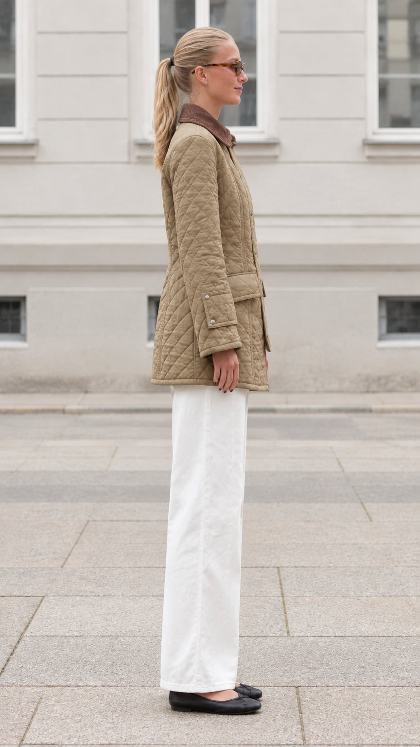 Side profile view of woman wearing khaki quilted field jacket