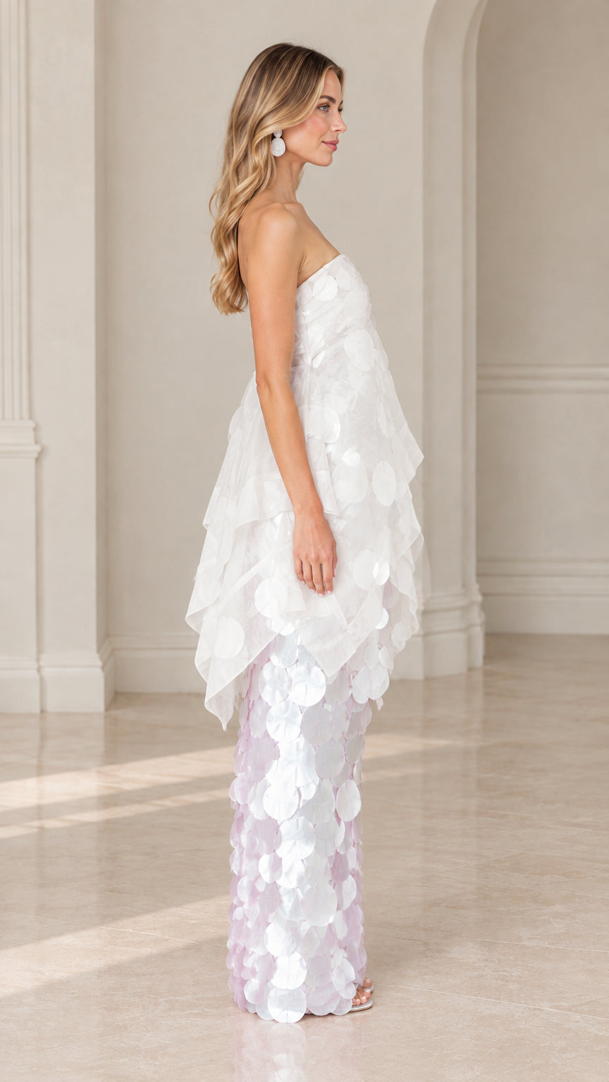 Side profile view of white tiered organza paillette evening dress