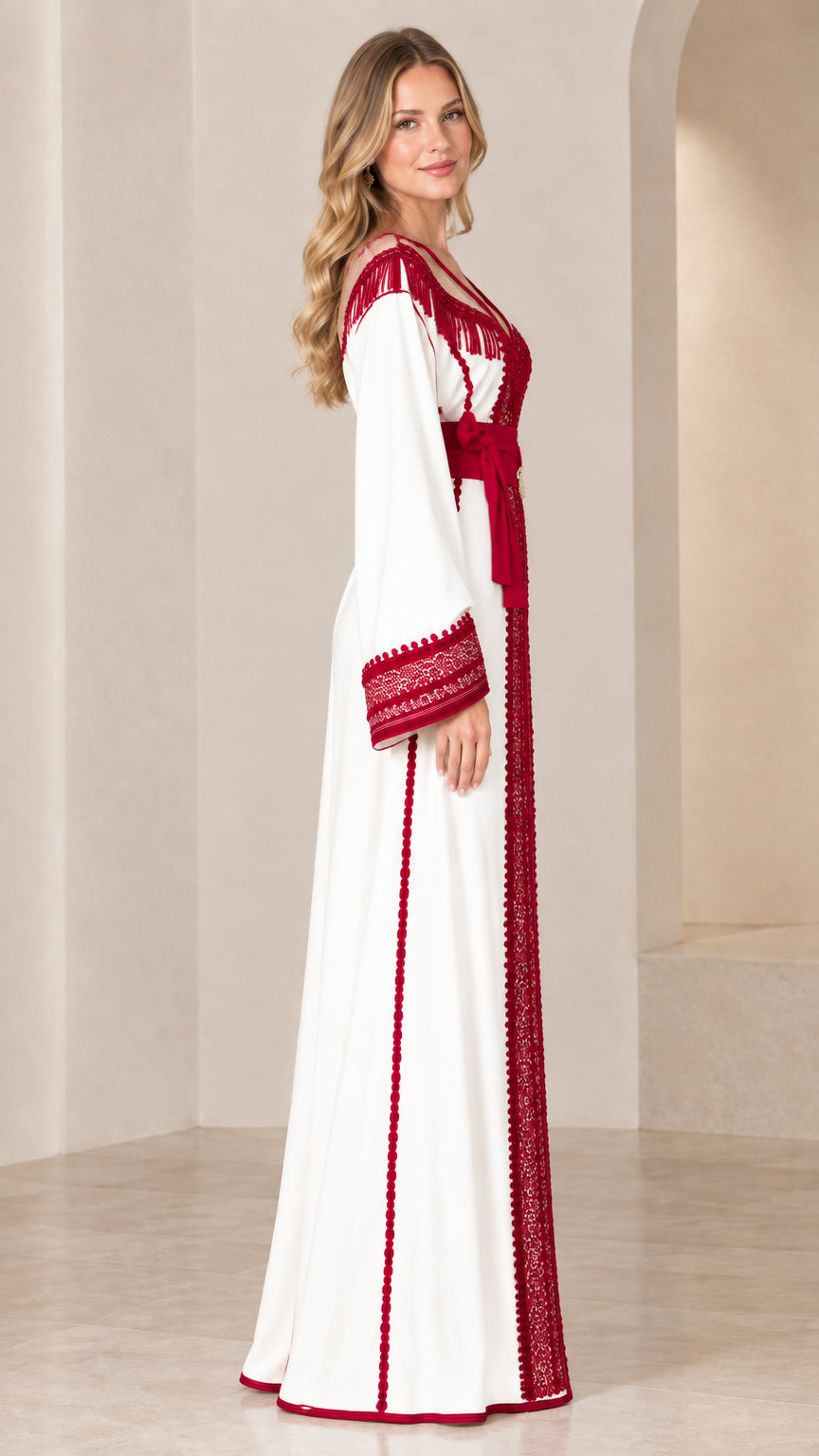 Side profile view of white caftan gown showing flowing maxi skirt and embroidered sleeve