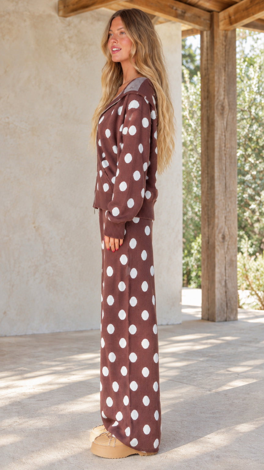 Side view of woman wearing brown polka dot knit two-piece lounge set