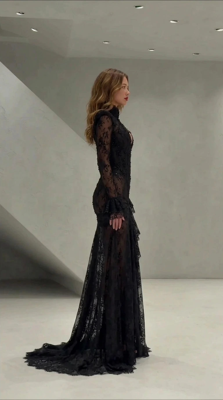 Side profile view of black long sleeve lace mermaid formal dress