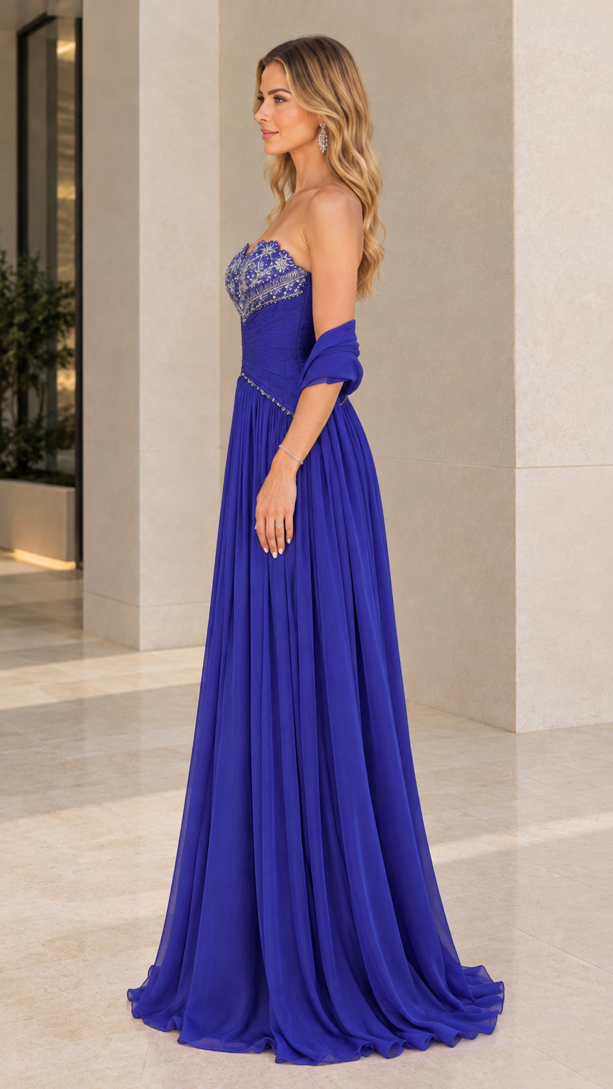 Side profile of model in Royal Blue floor-length strapless beaded chiffon gown