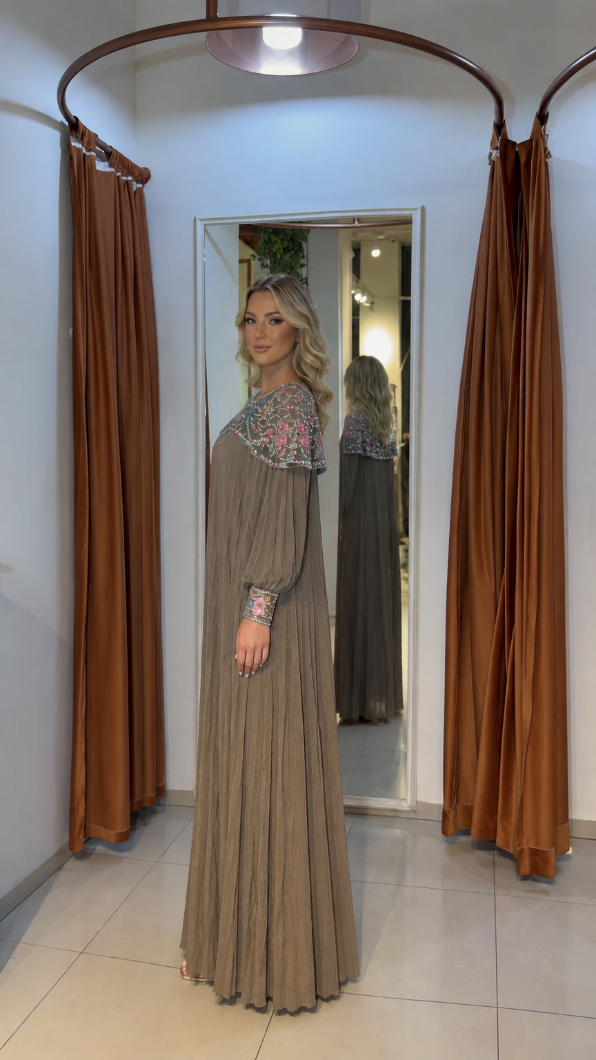 Side profile view of mocha long-sleeve pleated maxi gown