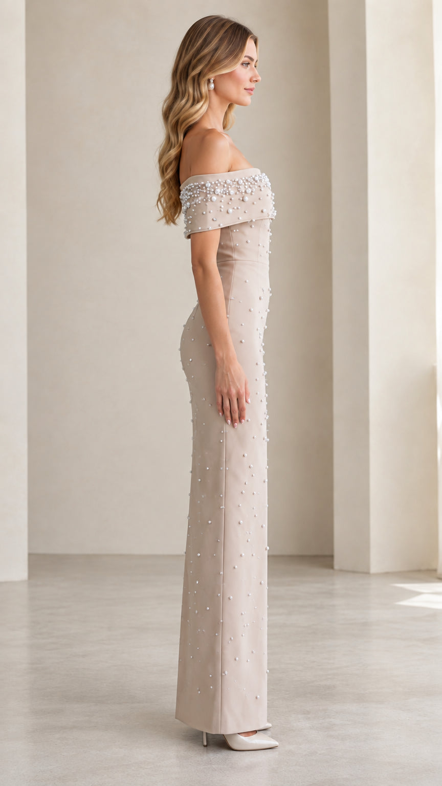 Side profile view of Champagne off-the-shoulder formal gown with pearl beading