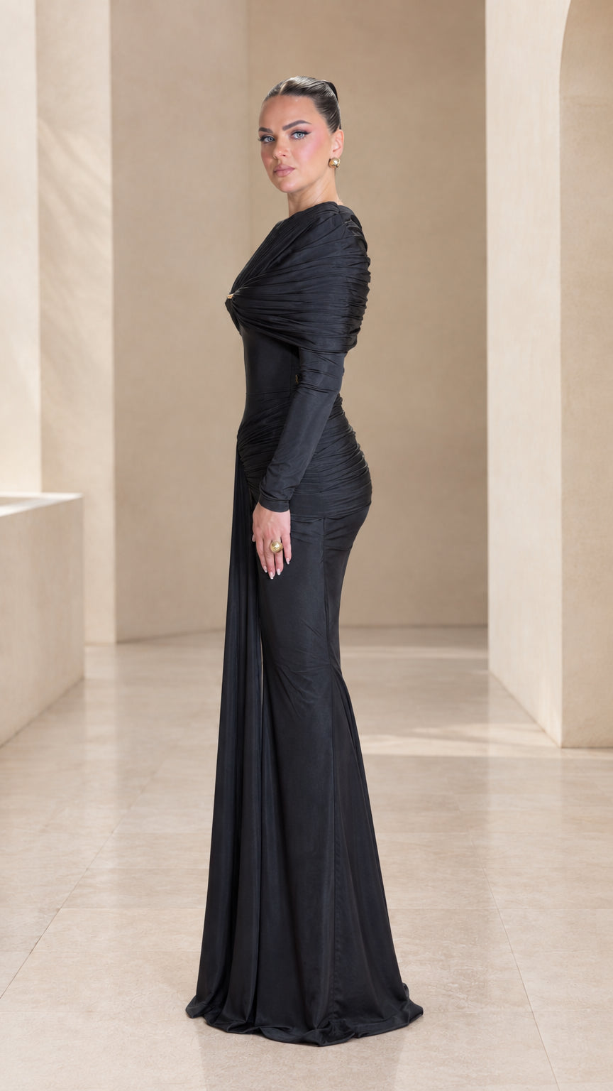 Side profile view of black long sleeve ruched mermaid evening gown