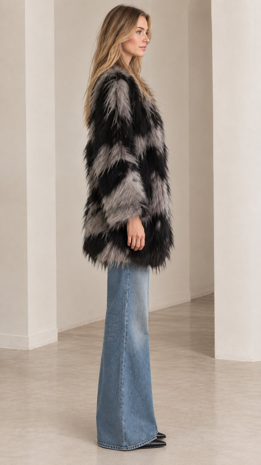 Side profile view of black and grey chevron fluffy faux fur jacket