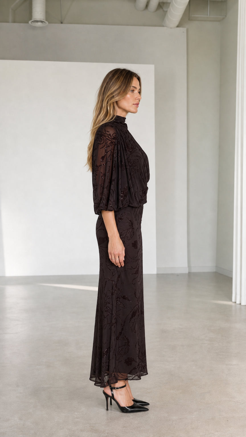 Side profile view of model wearing espresso brown draped one-shoulder formal dress
