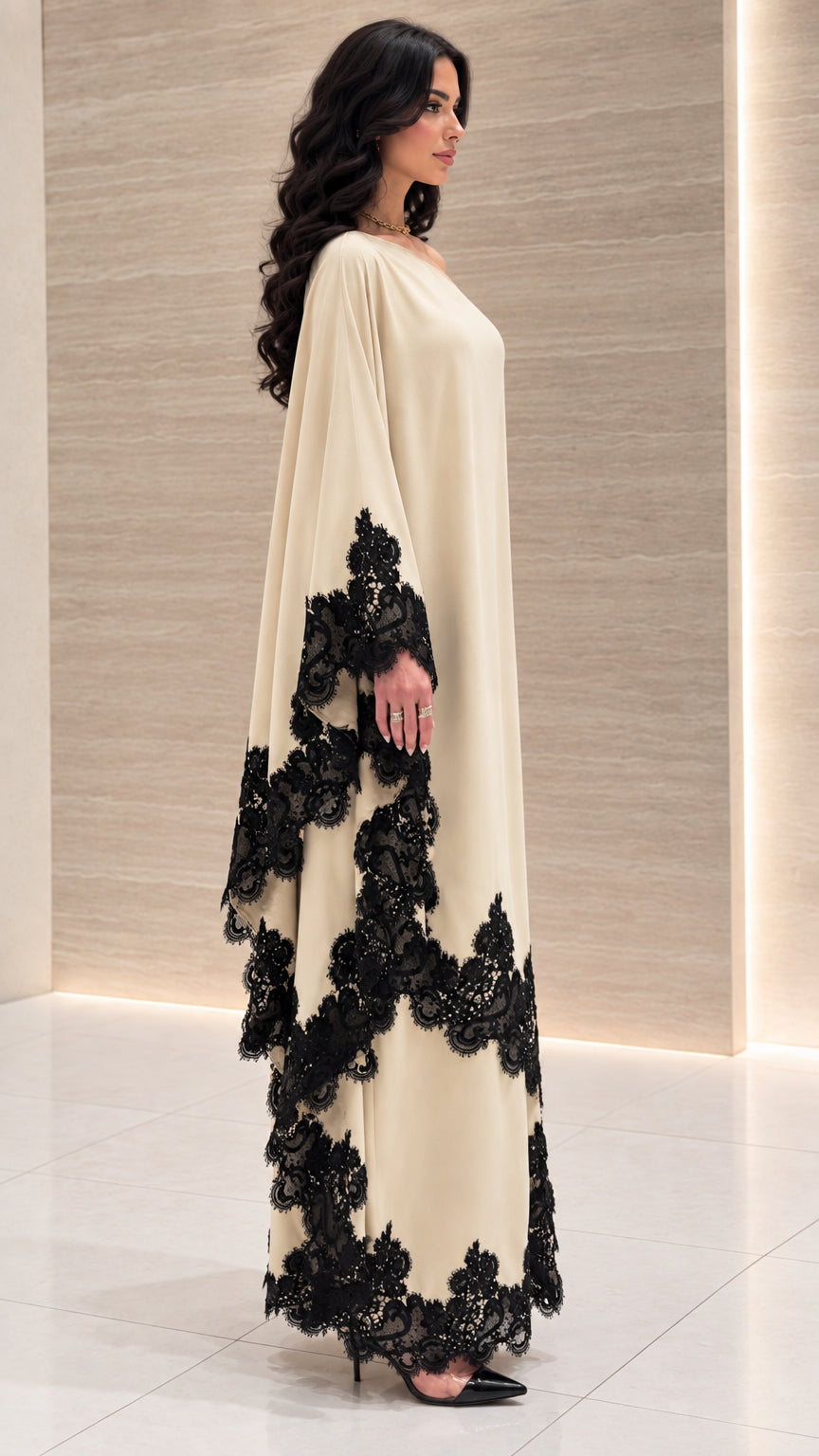 Side profile of woman in cream flowy kaftan maxi dress with lace hemline