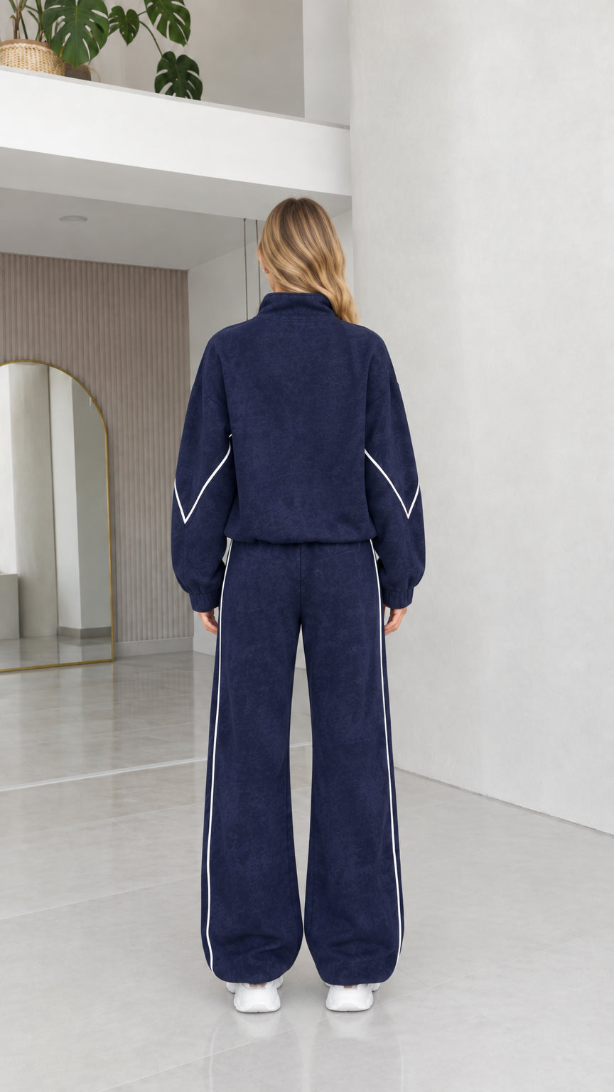 Back view of women's navy blue textured fleece tracksuit set
