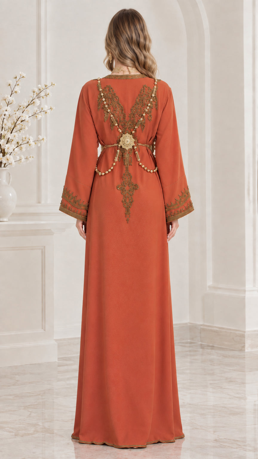Back view of woman wearing Rust Moroccan kaftan showing back embroidery and belt