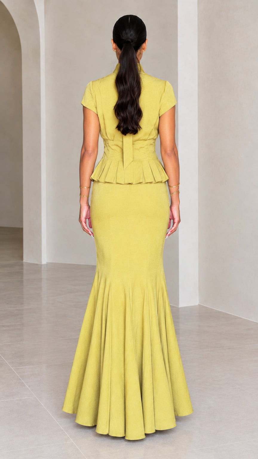Back view of Chartreuse peplum maxi dress showing tie back neckline and mermaid flare