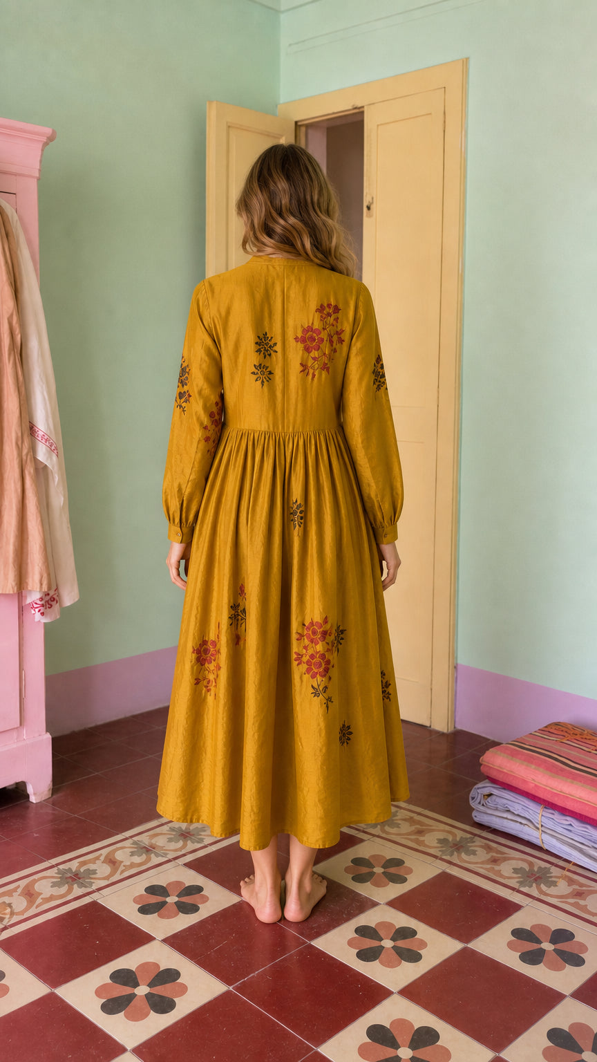 Back view of mustard embroidered midi dress