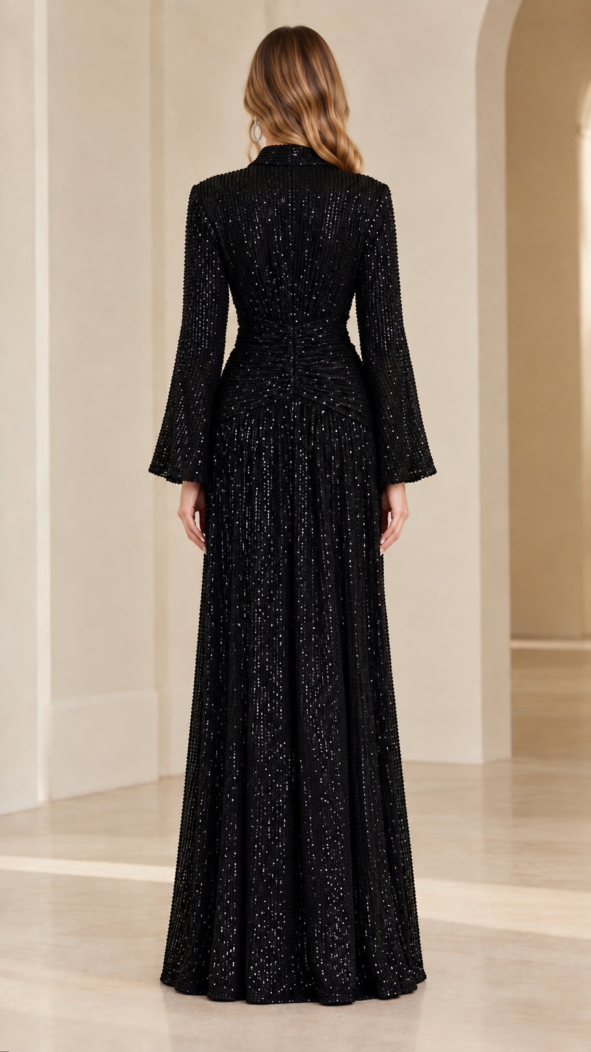 Back view of model in black sequin formal wrap gown
