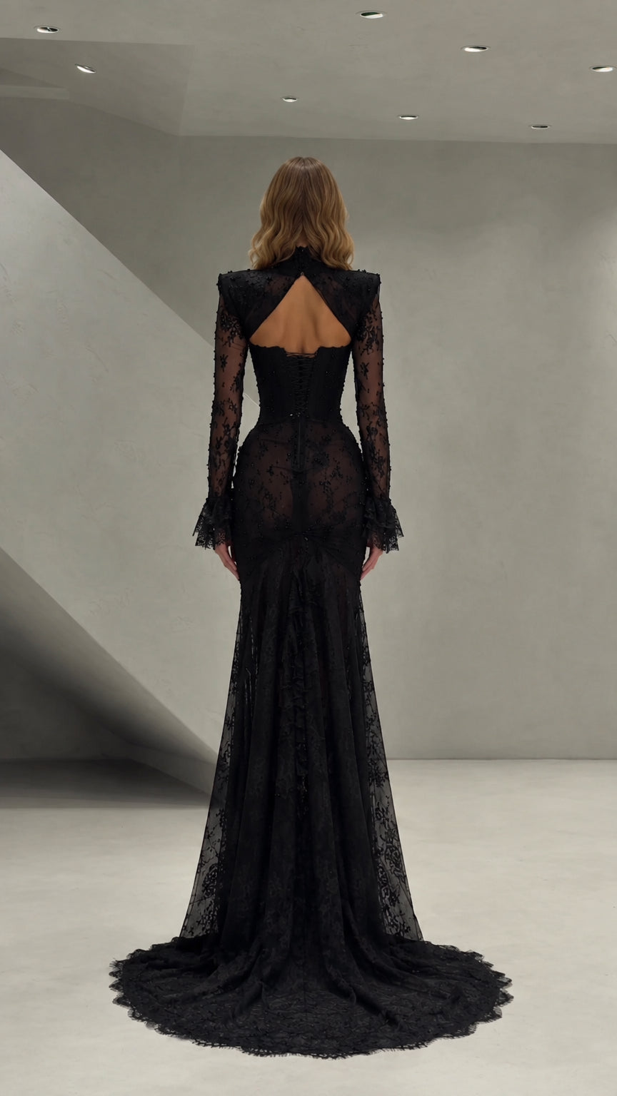 Back view of black lace evening gown showing cutout open back and train