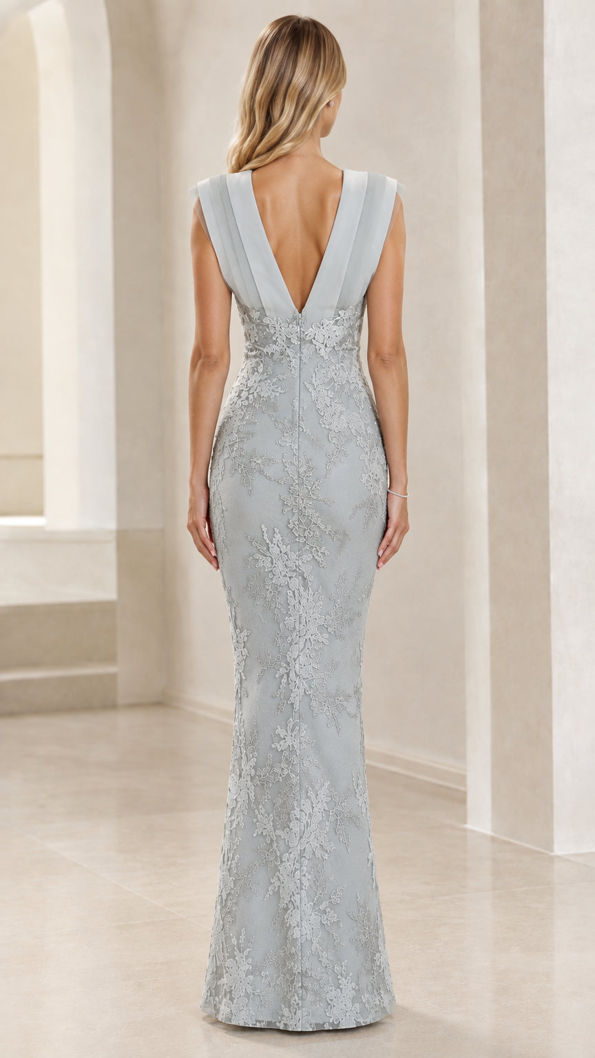 Back view of dusty blue evening gown showing deep V-back design