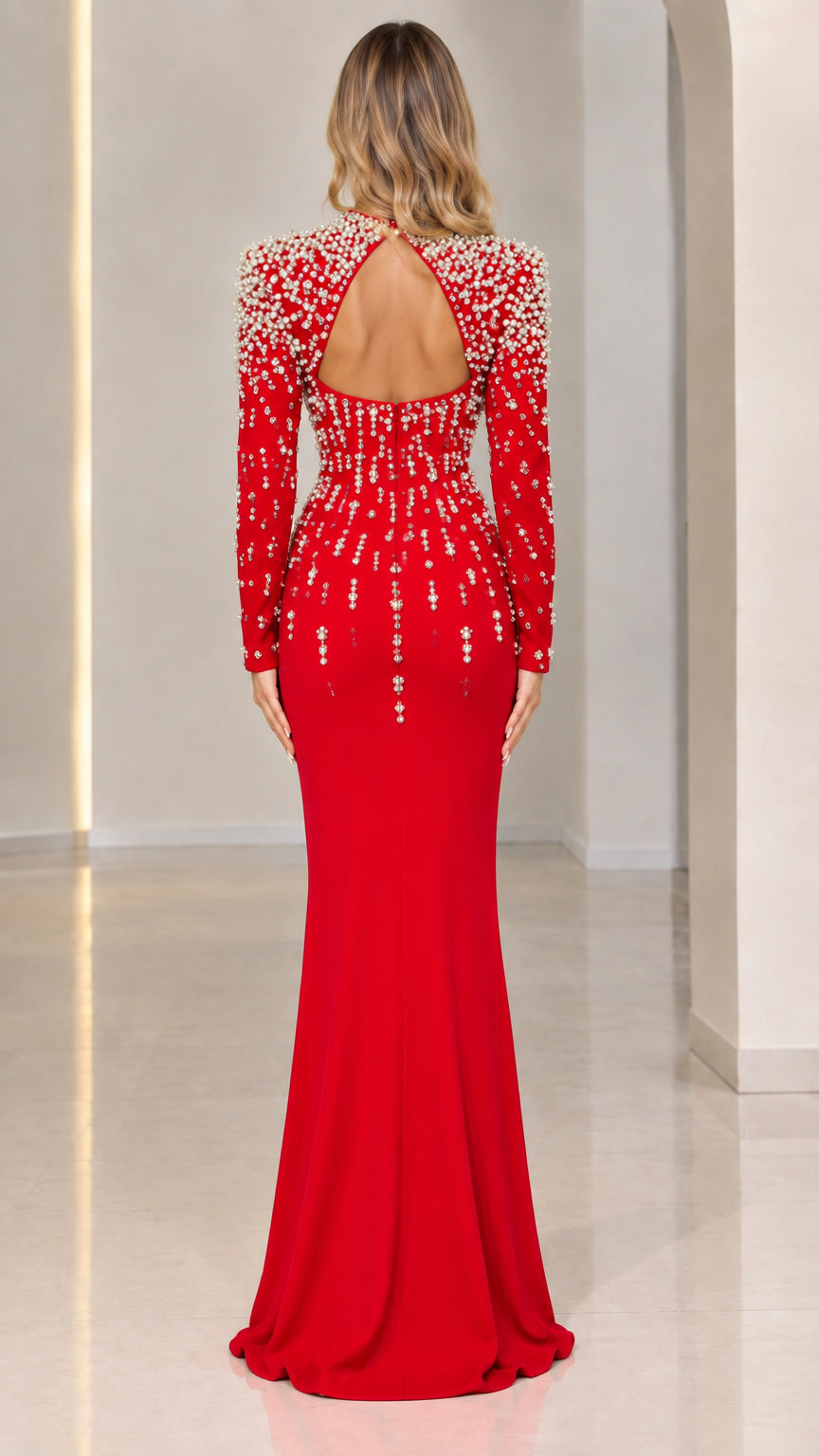 Back view of red evening gown showcasing open keyhole cutout back and beaded shoulders