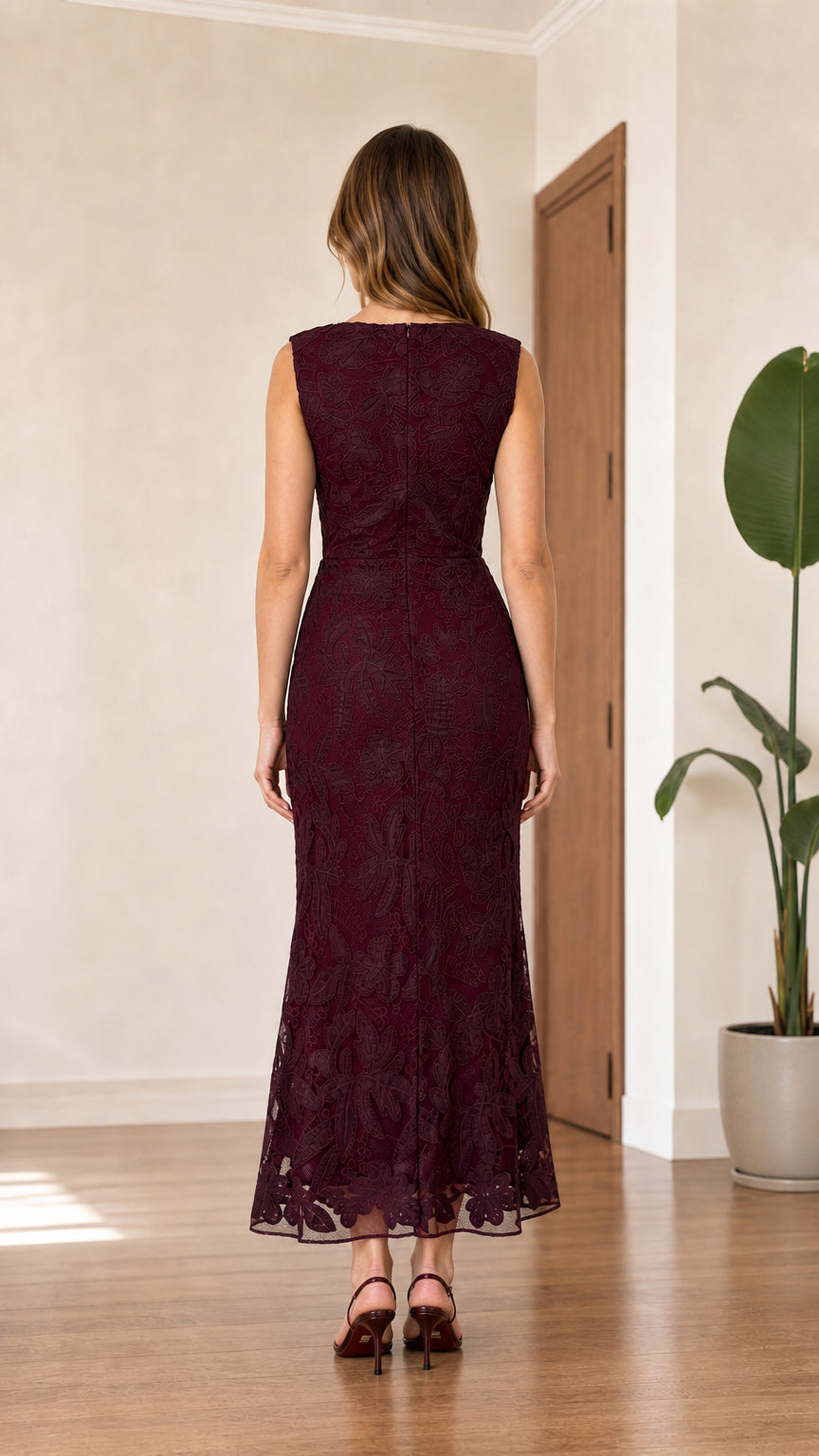 Back view of model wearing burgundy sleeveless floral lace evening dress