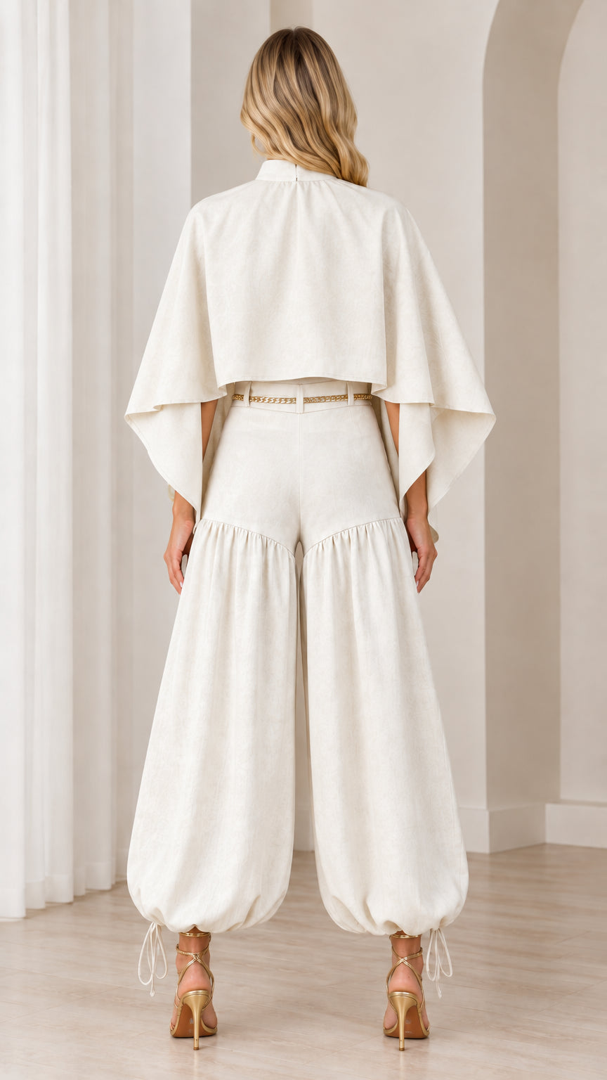 Back view of ivory two-piece cape and tie-ankle pants set