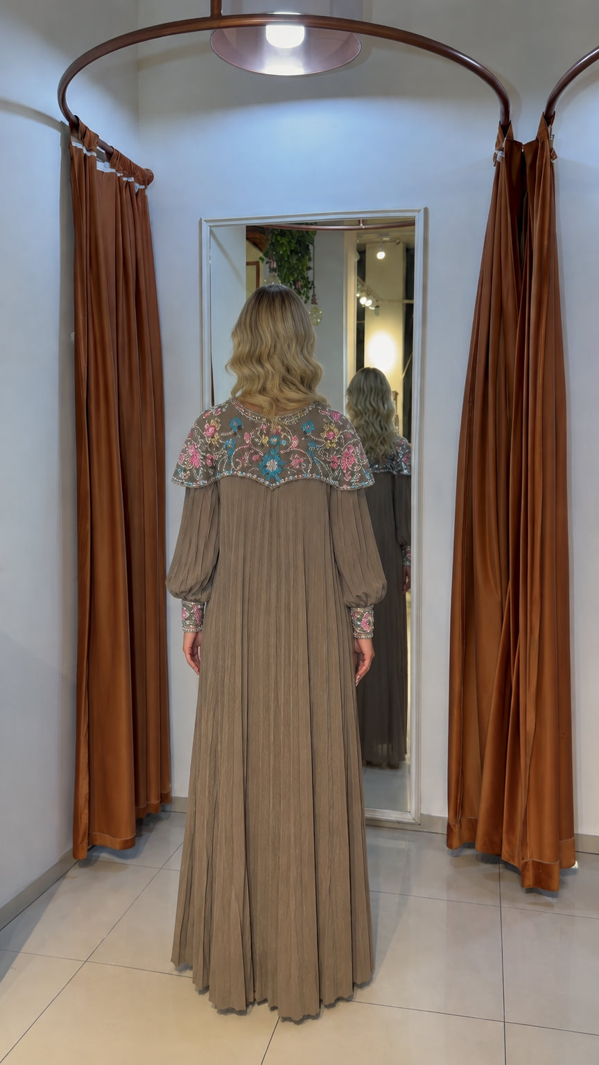 Back view of mocha pleated maxi dress highlighting embellished collar