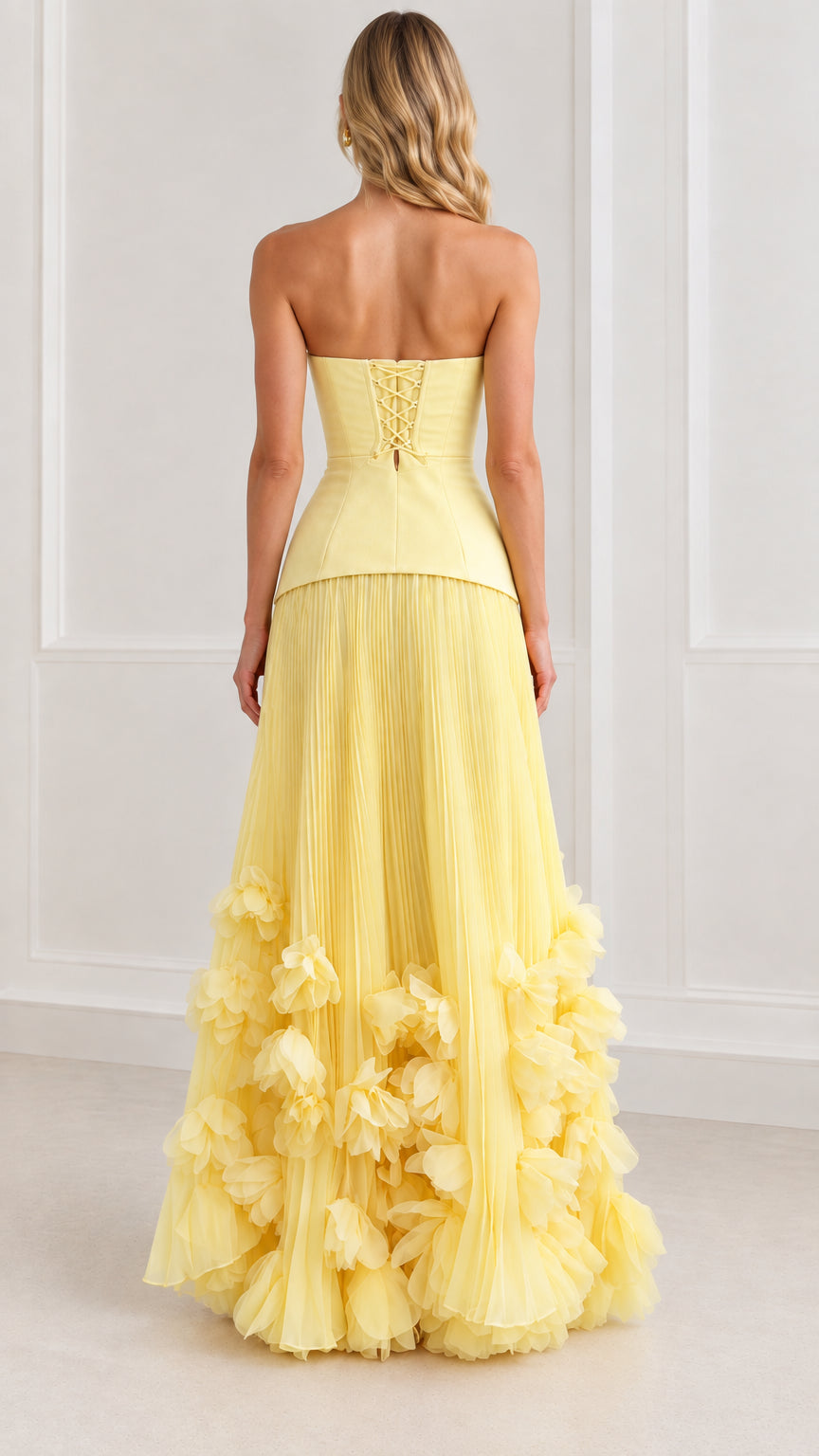 Back view of model wearing yellow strapless corset maxi dress showcasing lace-up tie closure