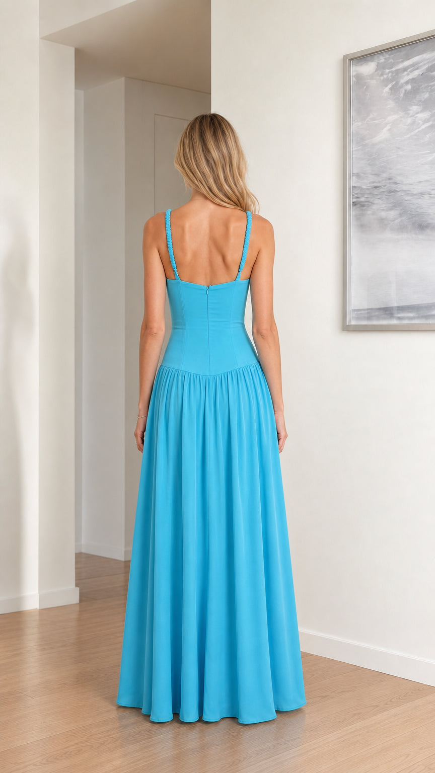 Back view of model in sky blue square back drop waist evening gown