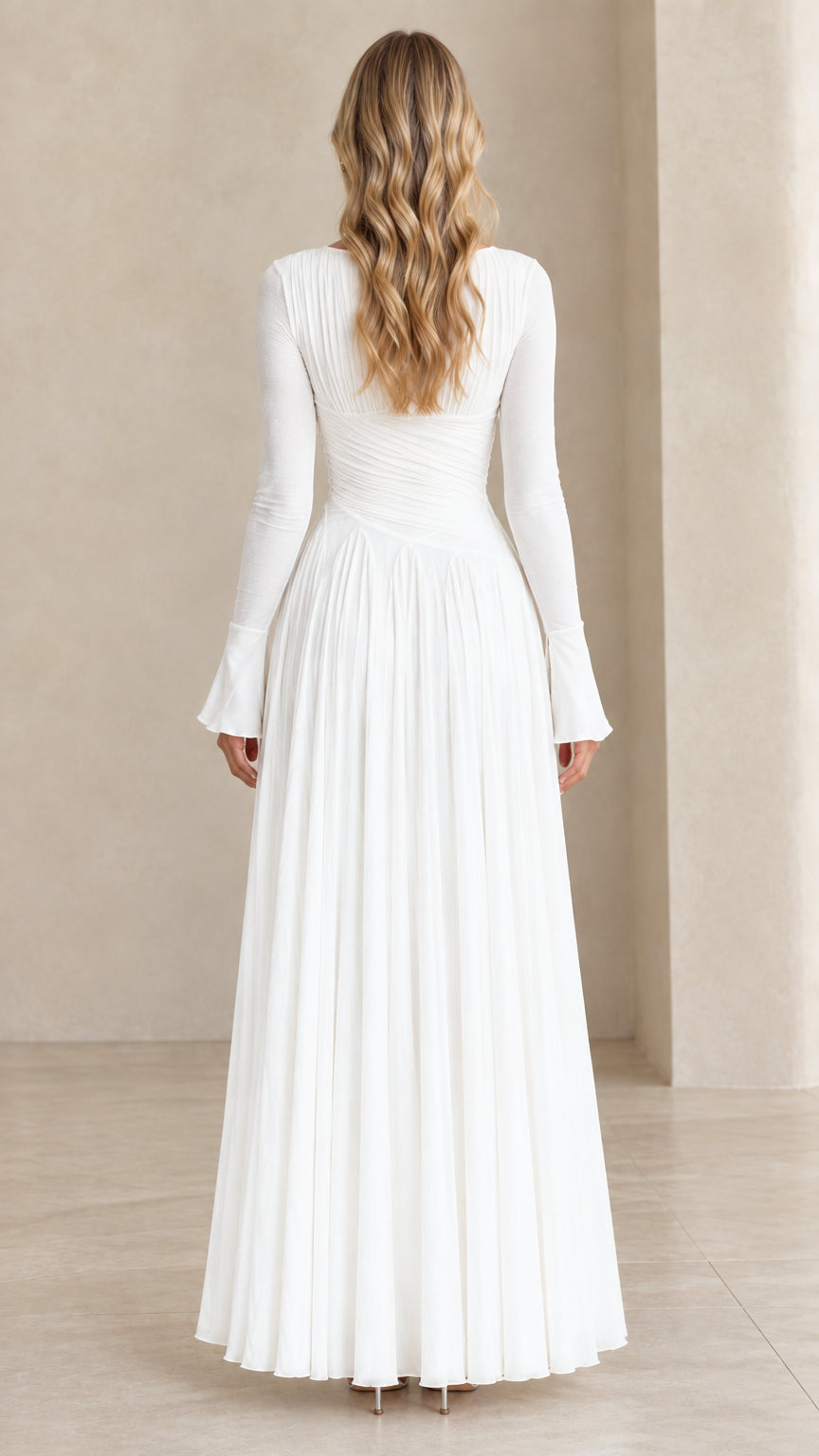 Back view of model wearing white floor-length pleated maxi dress