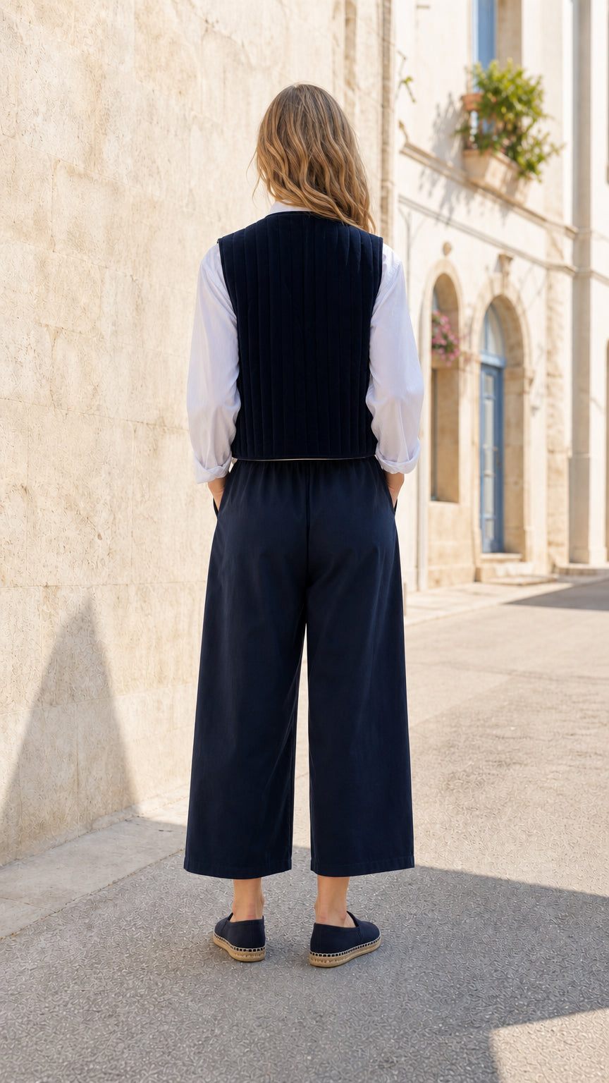 Woman wearing Navy quilted vest and wide-leg pants co-ord set, back view