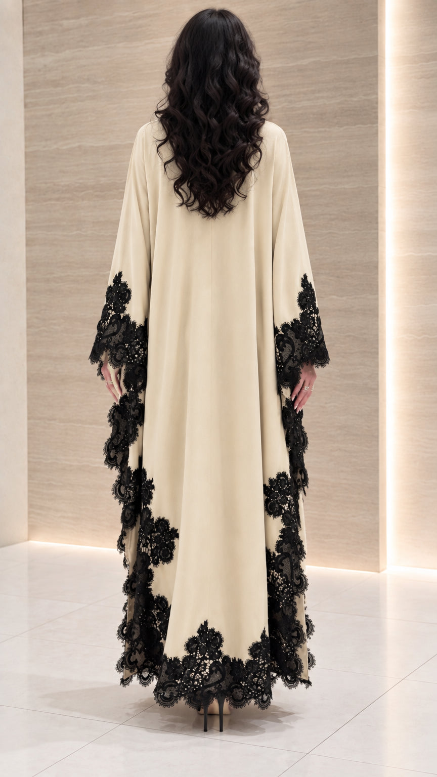 Back view of cream draped maxi dress showing flowing cape sleeves and lace details