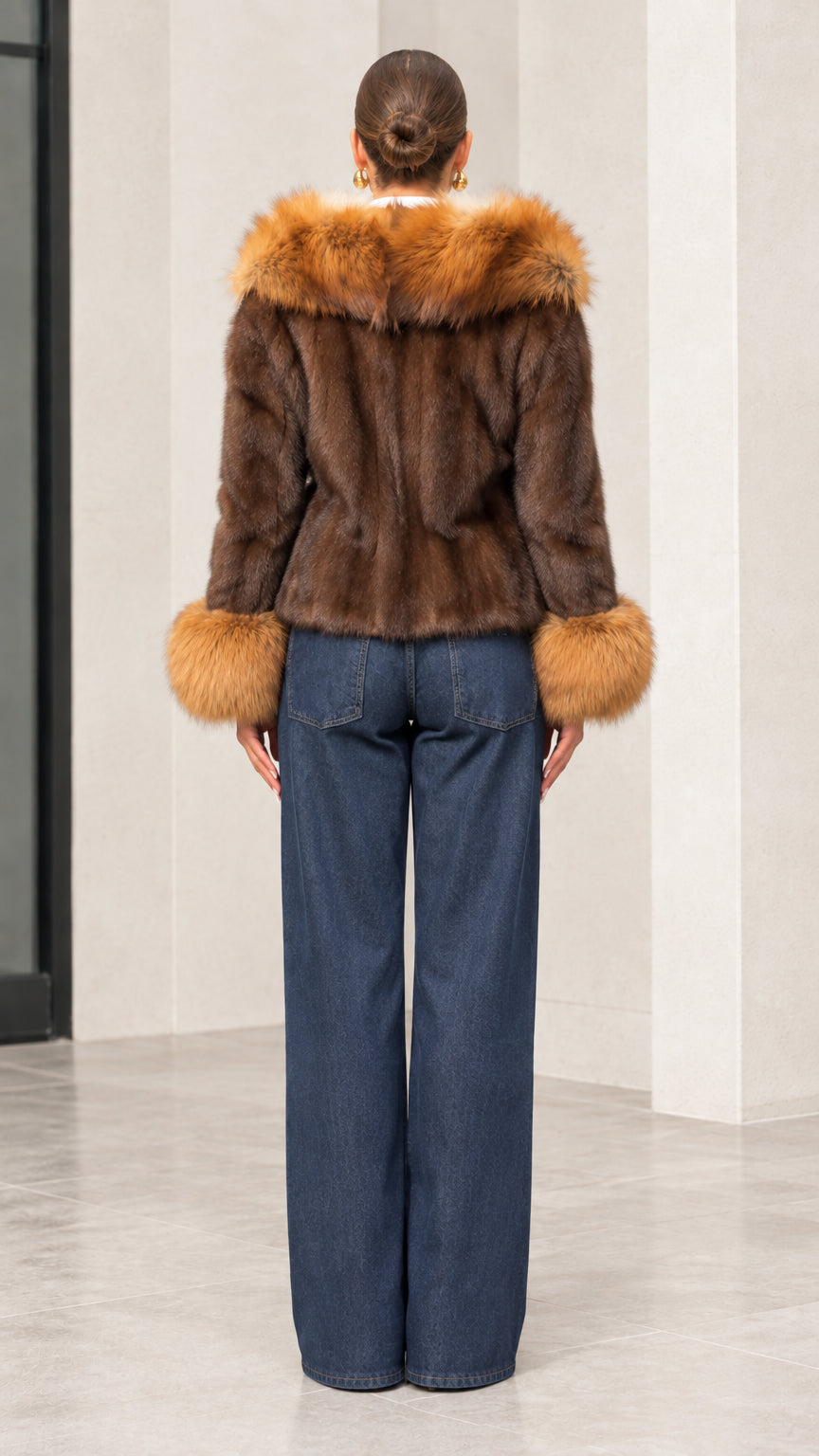 Back view of brown faux fur hooded short jacket showing plush hood detail and fitted silhouette