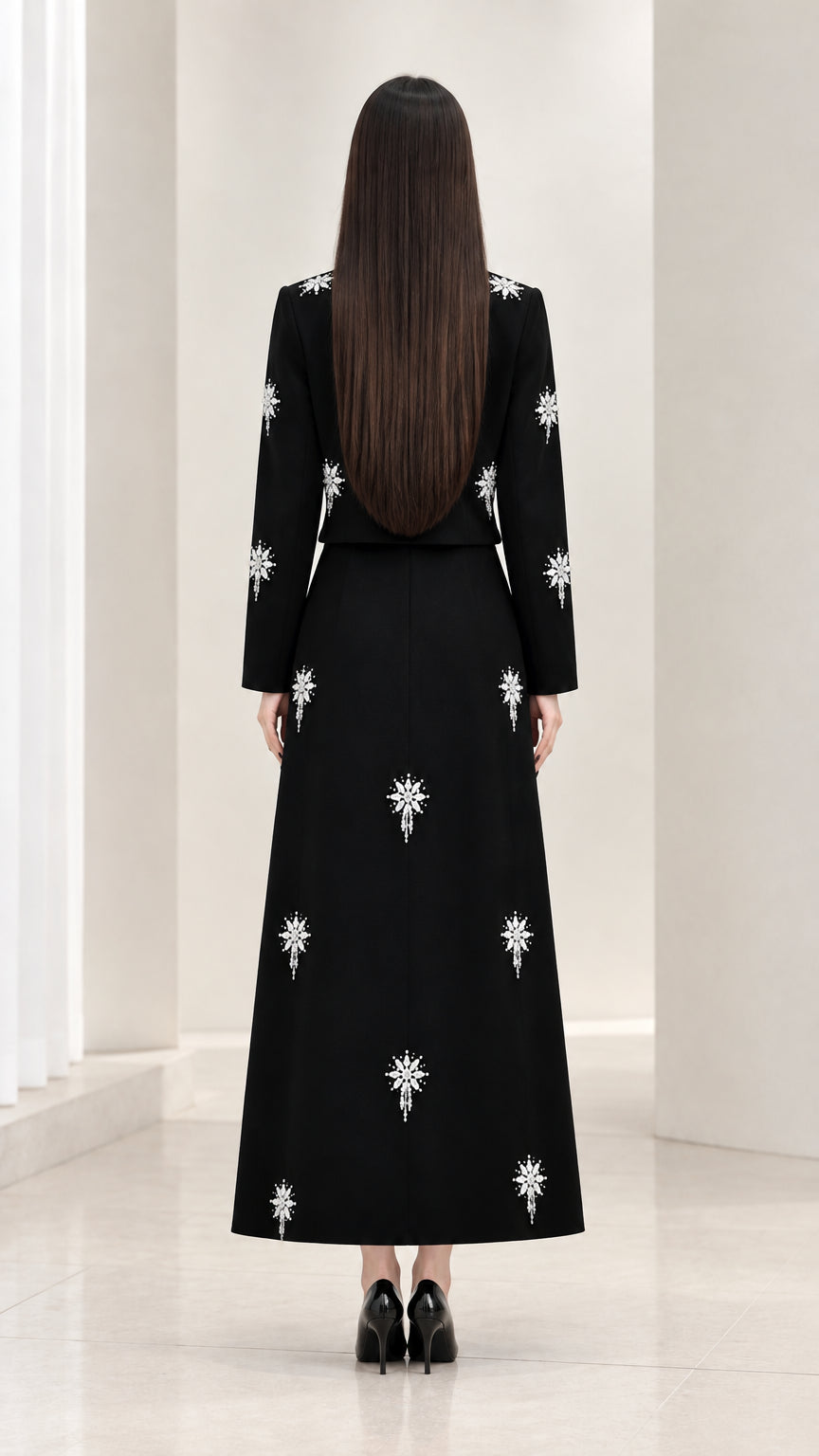 Back view of black long sleeve top and maxi skirt set