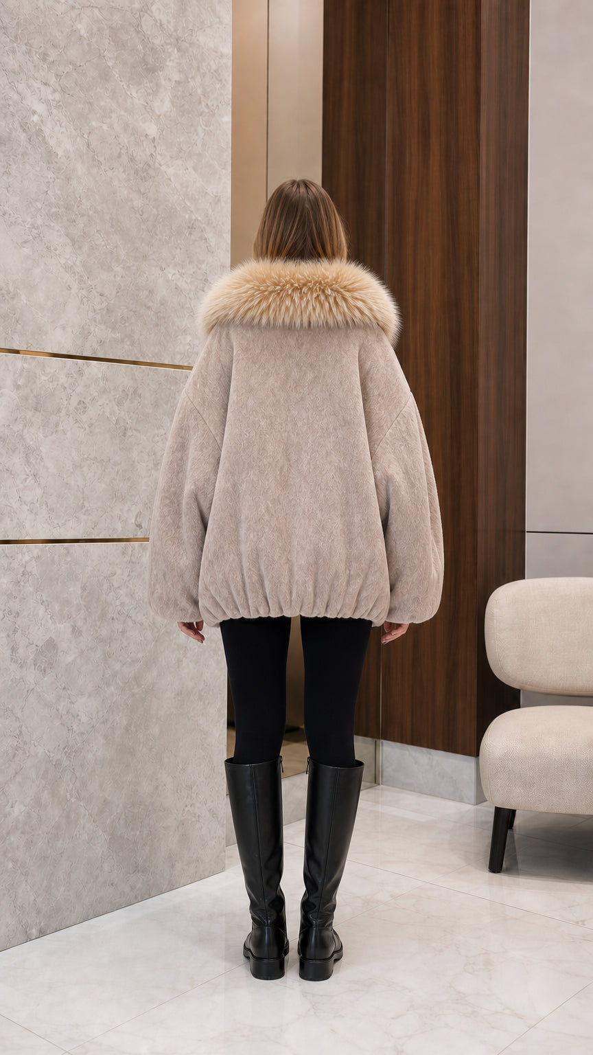 Back view of woman wearing beige fleece cocoon coat showing relaxed bubble hem