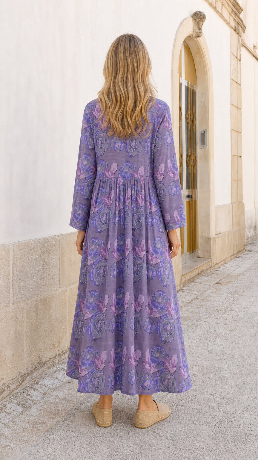 Back view of model in purple floral maxi dress