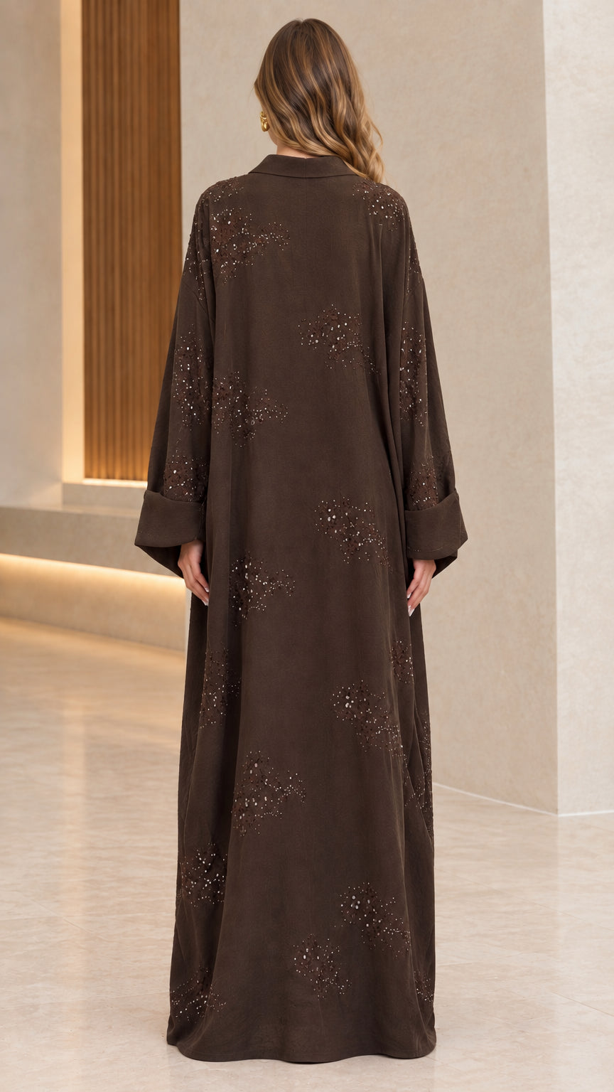 Back full-length view of woman wearing flowing brown collared abaya maxi dress