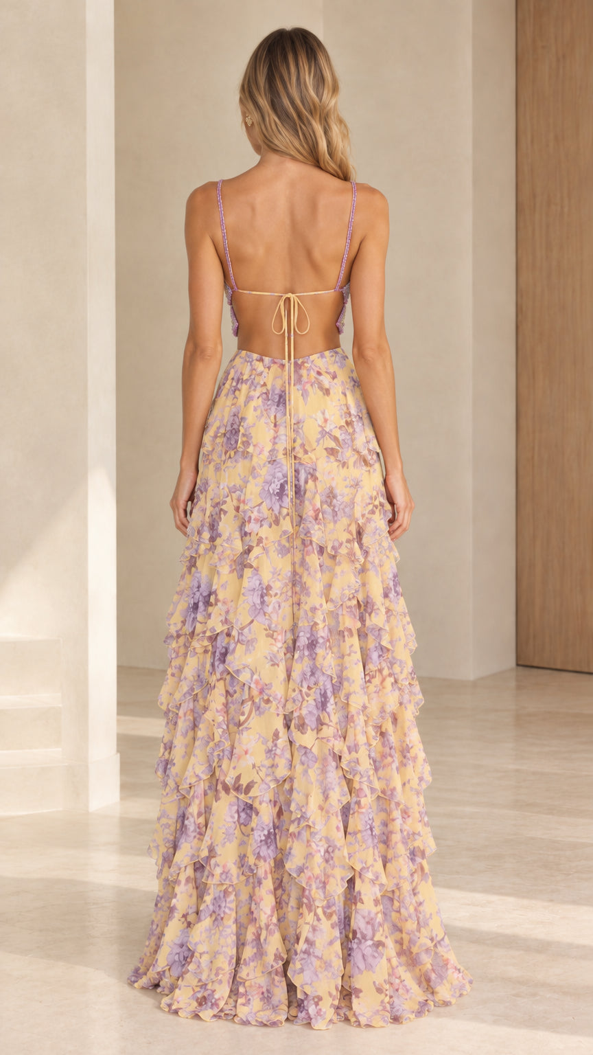 Back view of model in yellow floral maxi dress showing open tie back