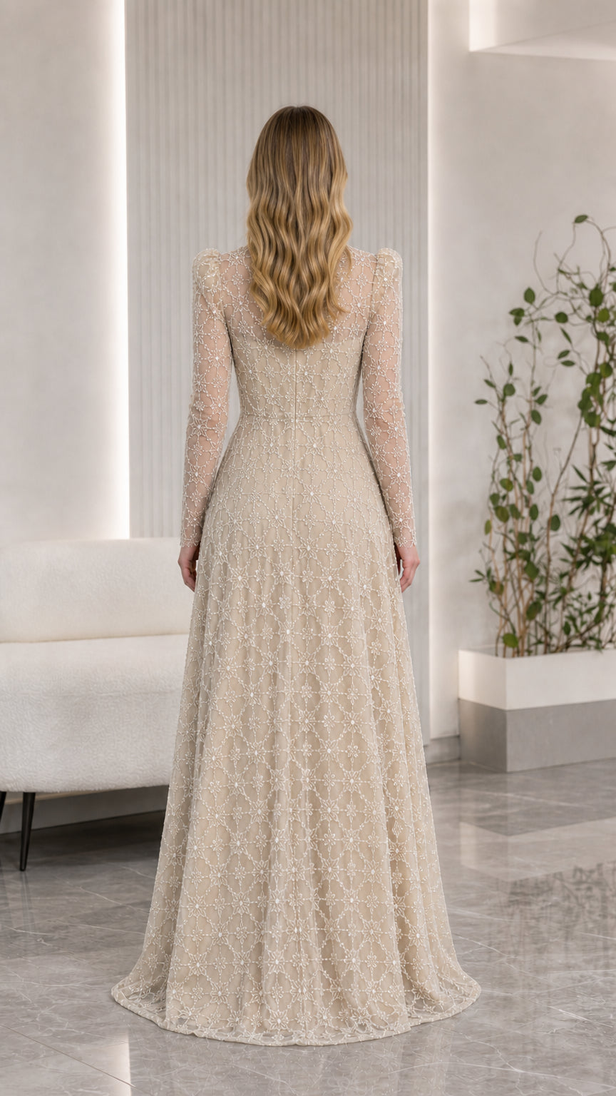 Back view of champagne illusion long sleeve floor-length evening gown