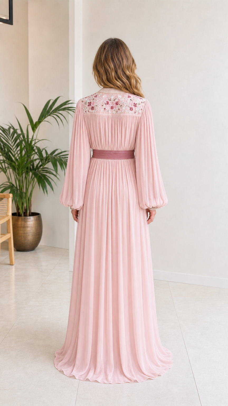 Back view of blush pink embroidered kaftan dress showing pleated skirt drape