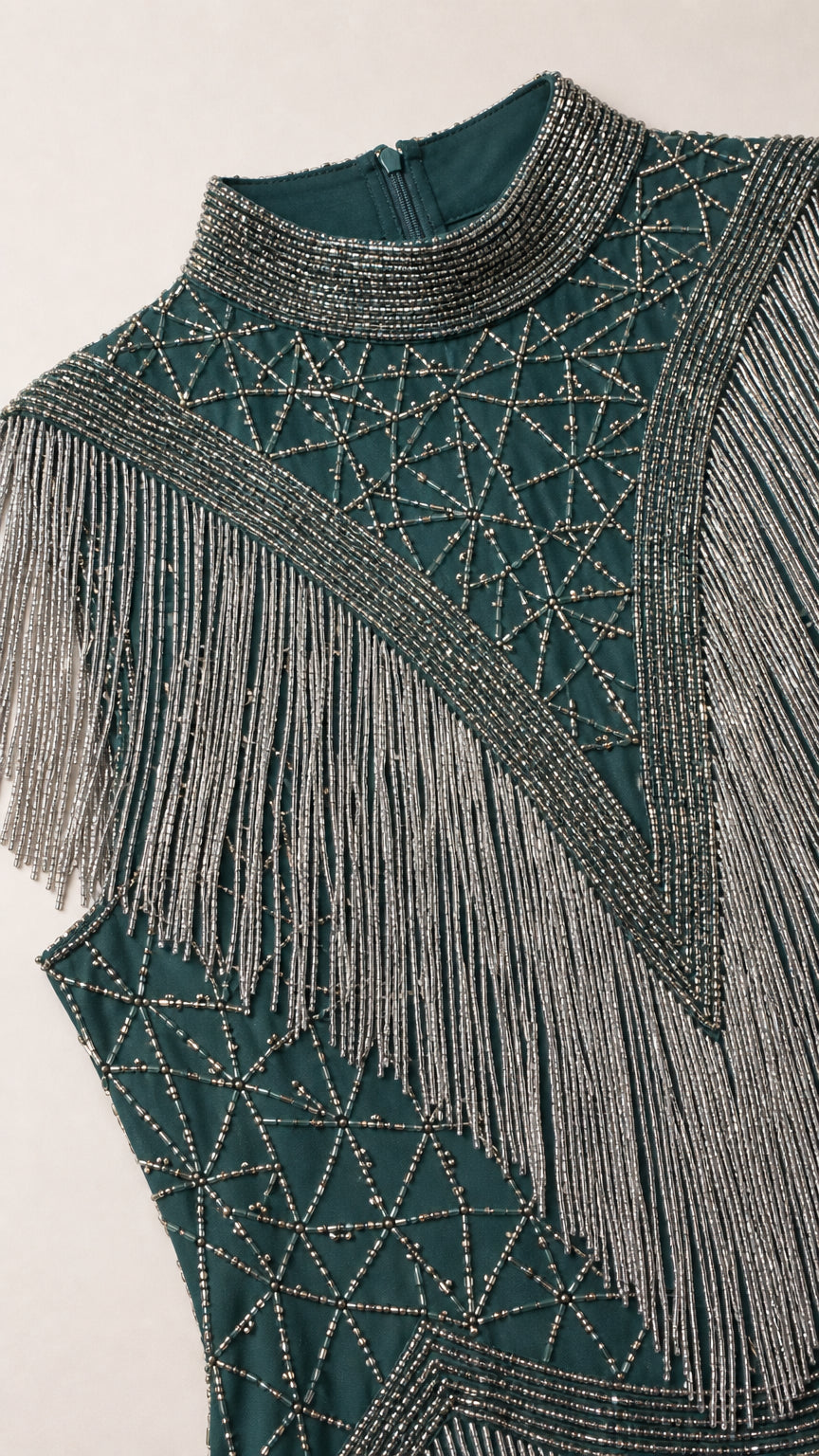 Close-up detail of high neckline and intricate geometric beadwork with fringe