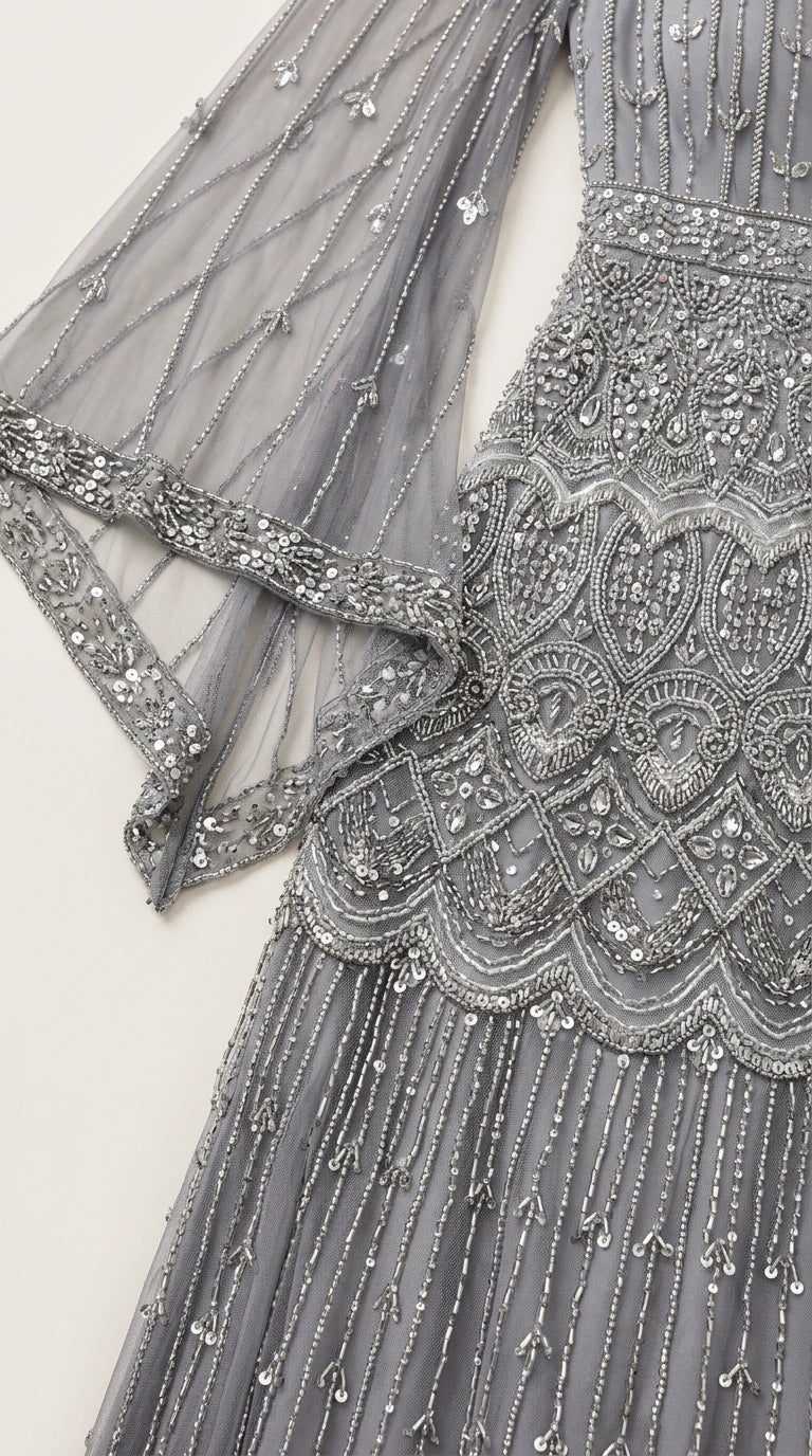 Close-up of intricate scalloped beadwork and sheer flutter sleeve detail