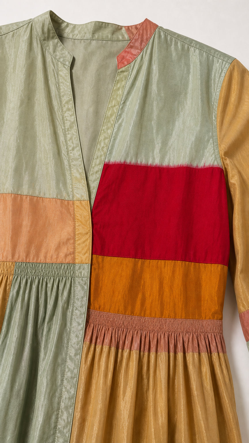 Close-up detail of the fabric, V-neckline, and colorblock panels
