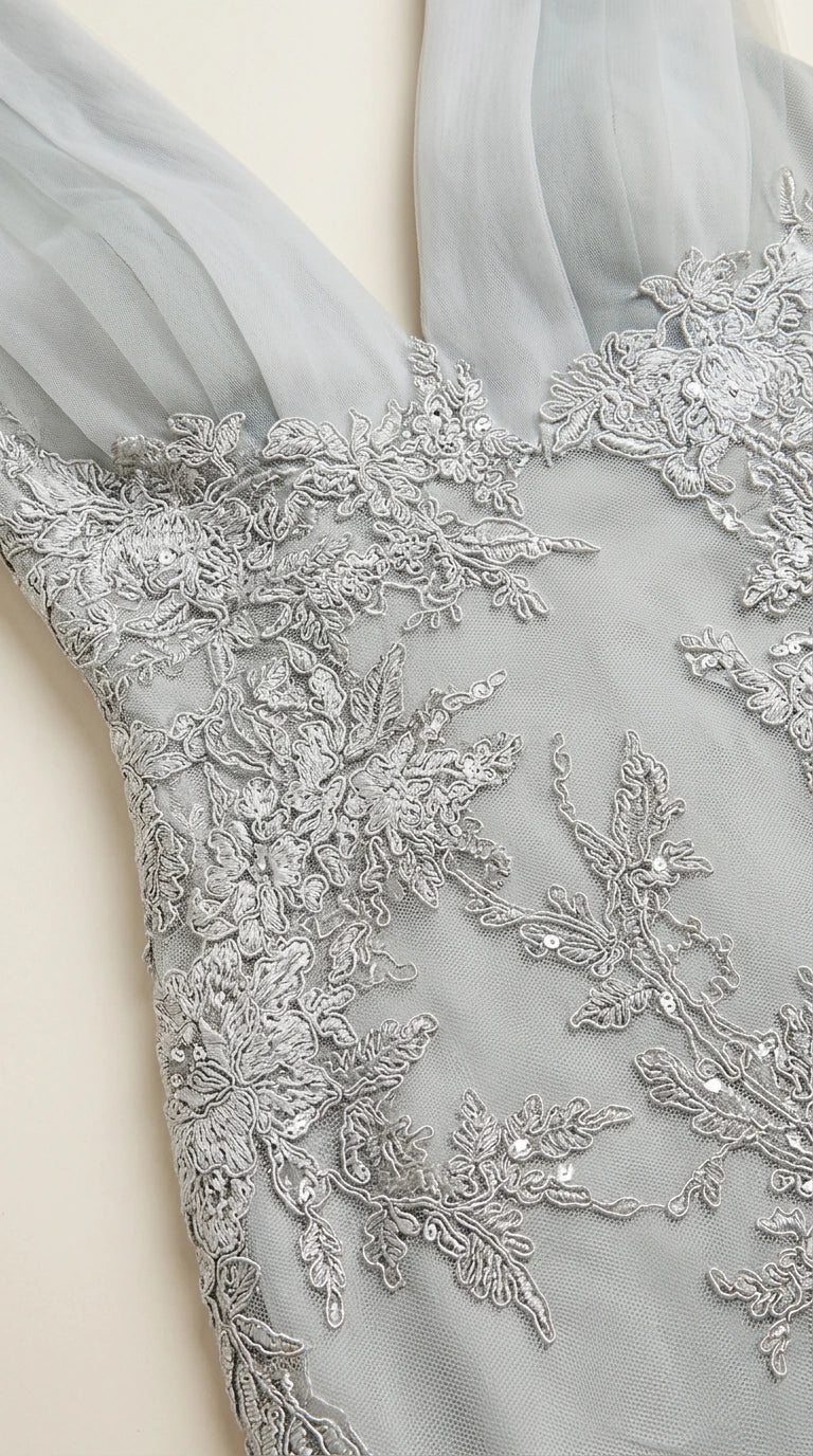 Close-up detail of delicate floral lace embroidery and subtle sequin embellishments